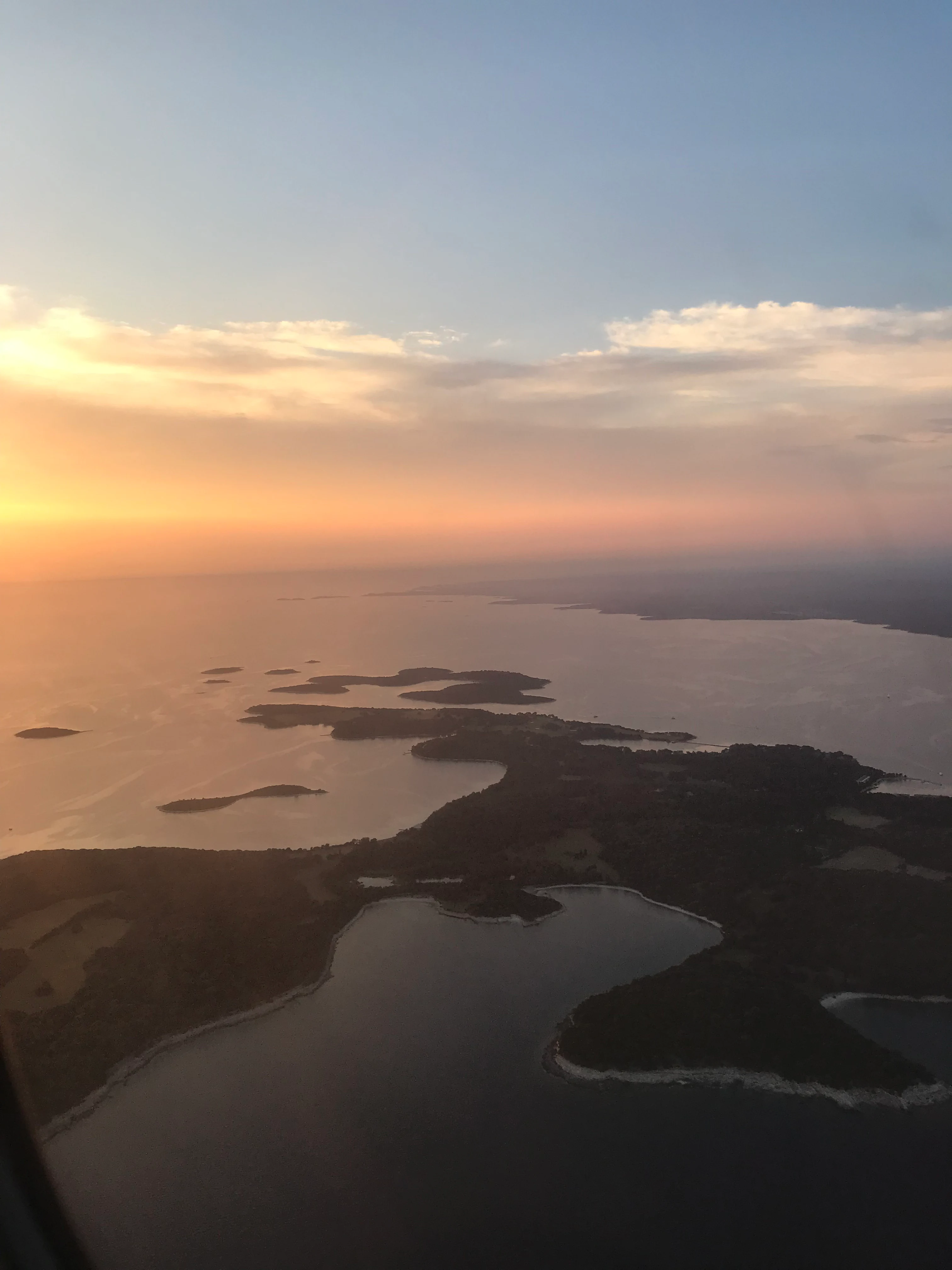 Aerial view of islands and sea at sunset showing the Brijuni archipelago from above