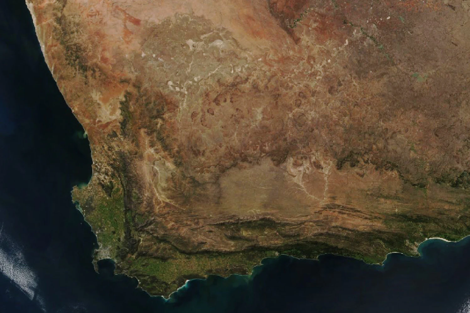 Top-down satellite view of the southwestern tip of South Africa, showing the coastline, mountainous terrain, and vegetation patterns of the Cape Floristic Region.