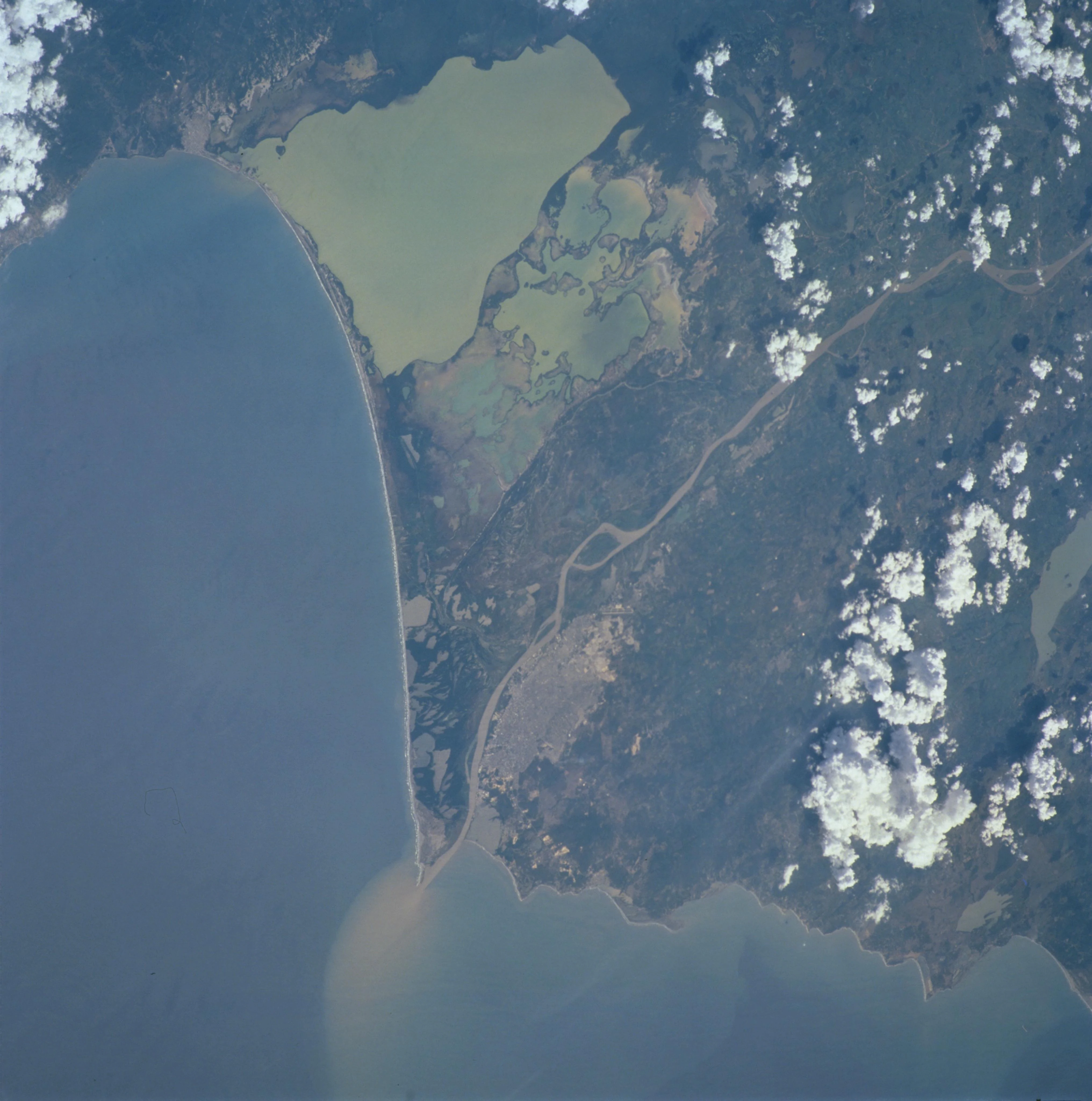 Satellite image showing the Magdalena River delta where sediment plume enters the Caribbean Sea, with coastal waters and landmasses visible