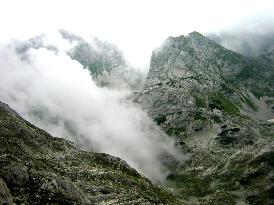 Rugged mountain peaks and valleys with fog in Durmitor National Park