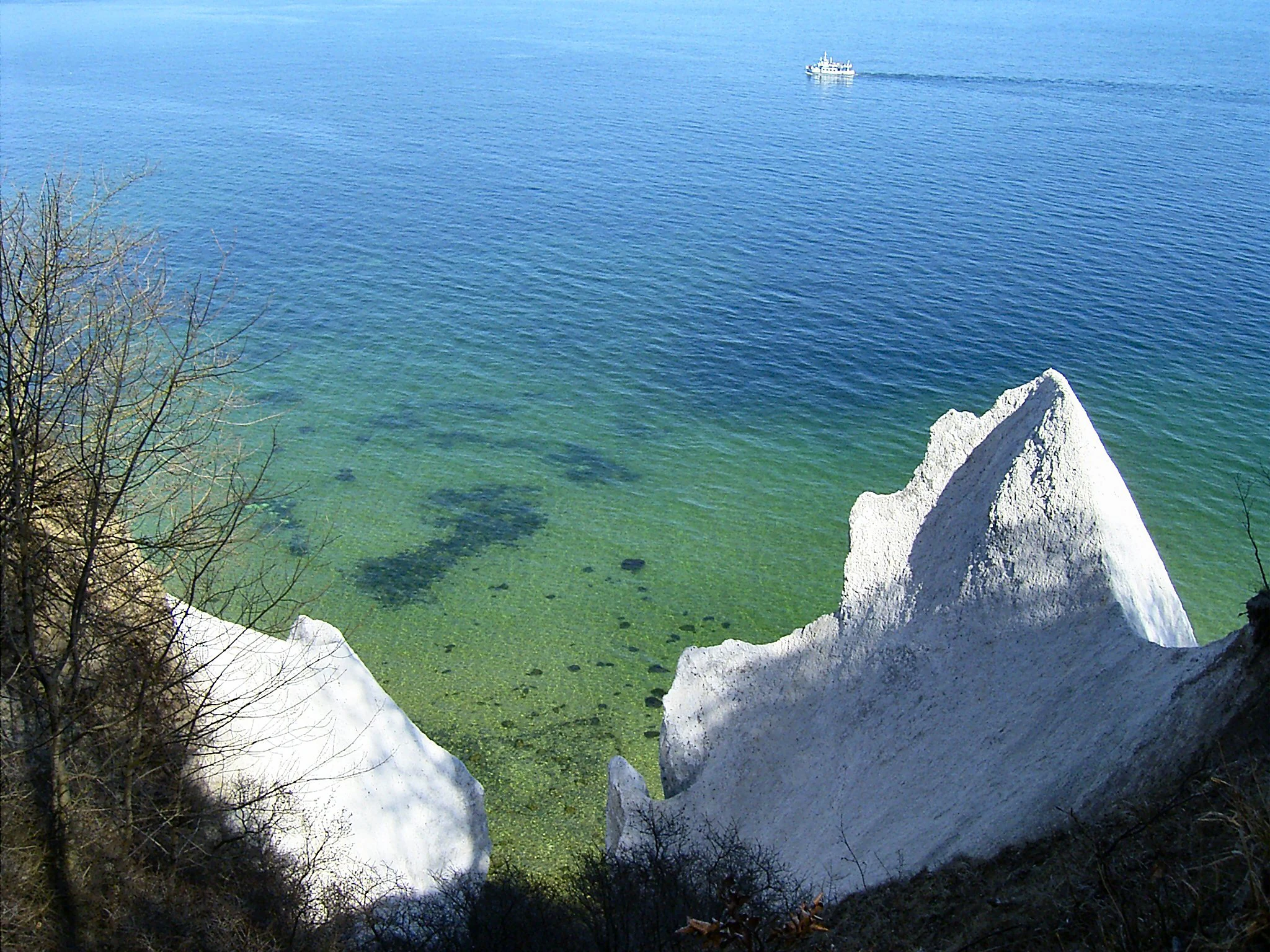 White chalk cliffs at Wissower Klinken in Jasmund National Park with turquoise water and a distant ship