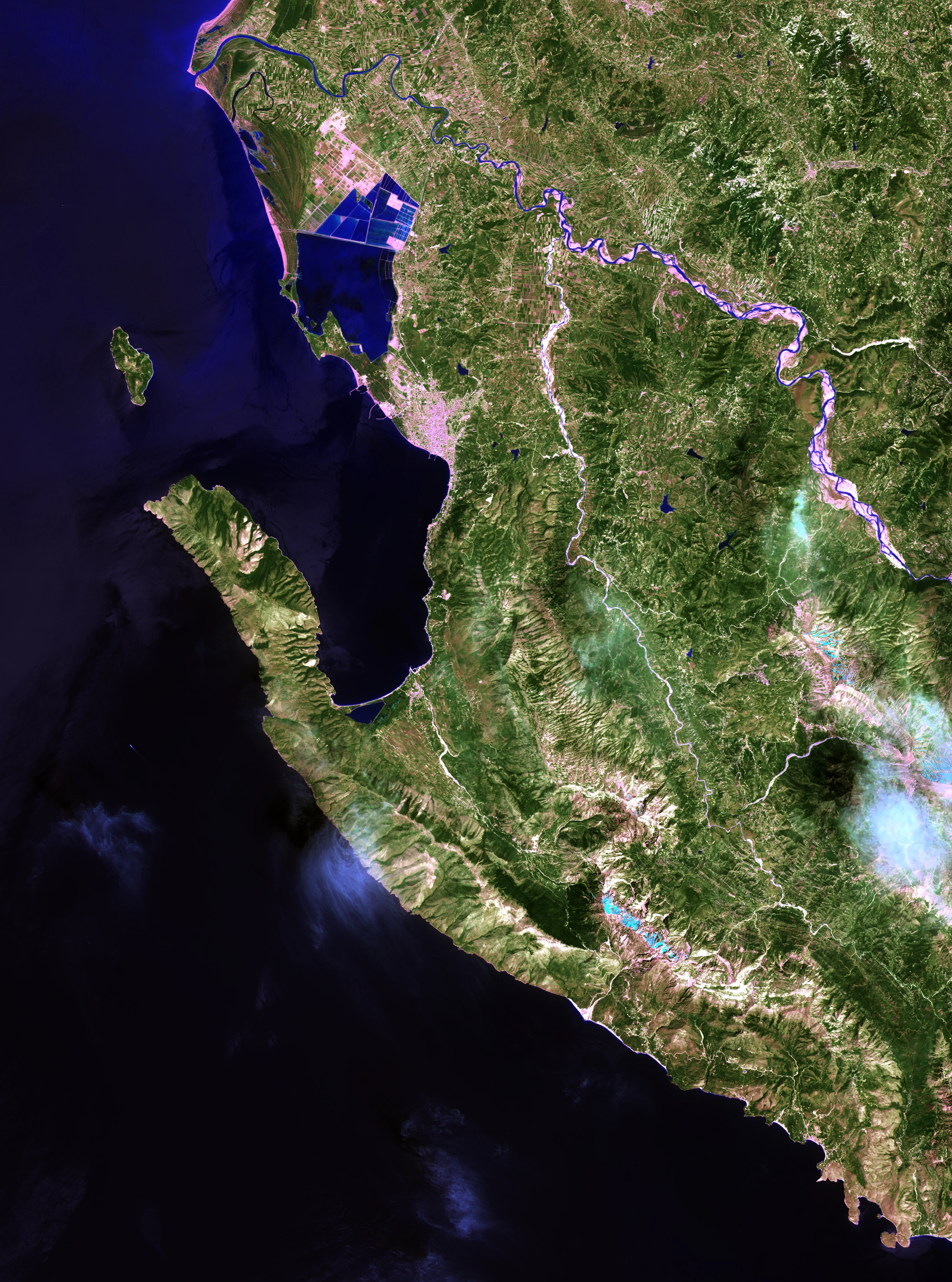 Satellite imagery showing the rugged coastline of the Karaburun Peninsula extending into the Ionian Sea, with the Bay of Vlorë visible to the north.