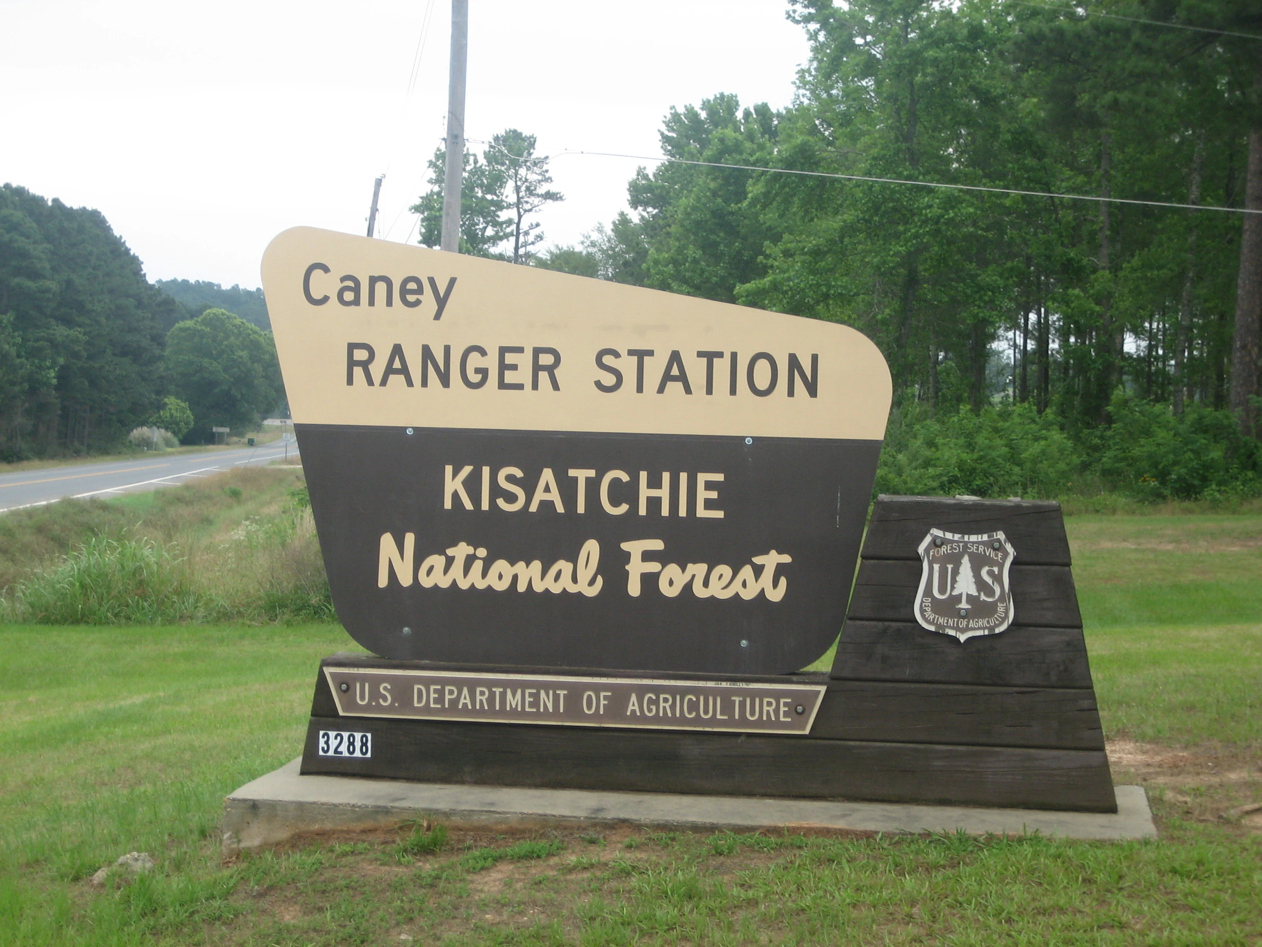 A brown and cream-colored entrance sign for the Caney Ranger Station in Kisatchie National Forest, featuring the U.S. Forest Service logo.