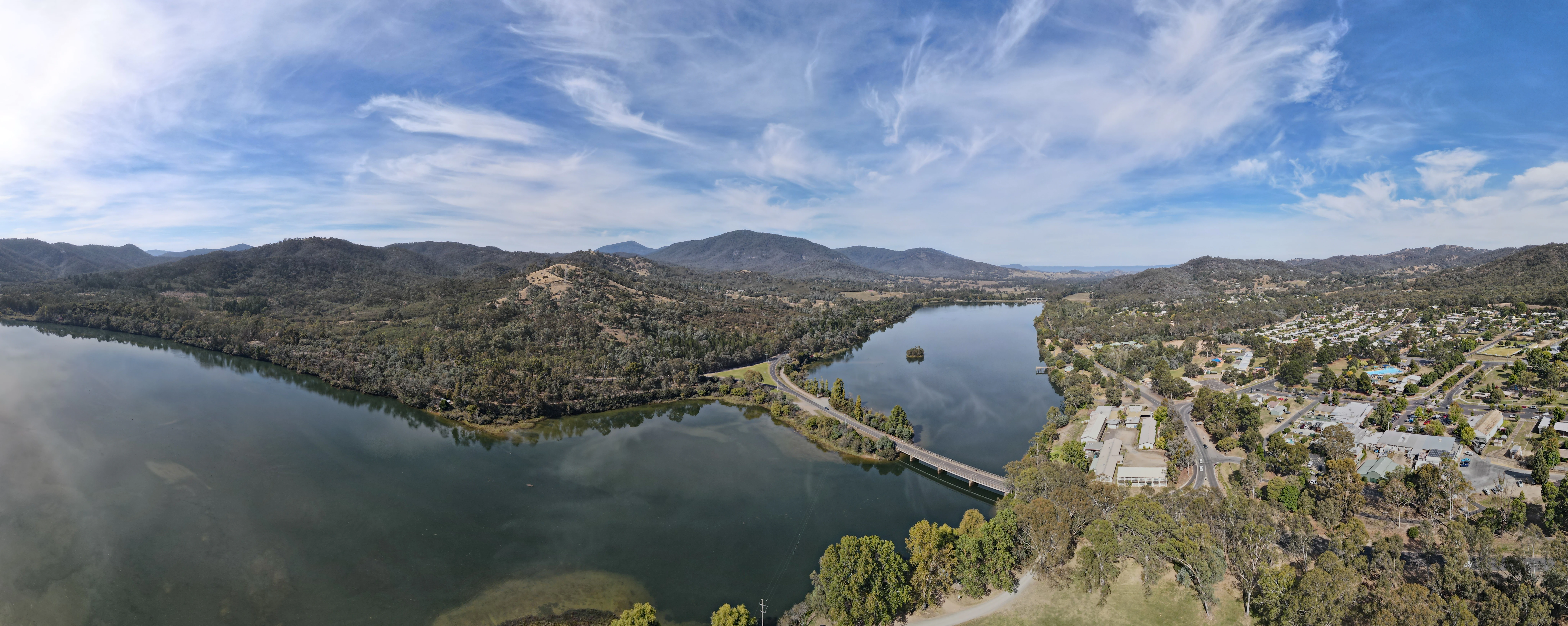 Aerial view of Lake Eildon National Park showing a large body of water, hills, and a bridge