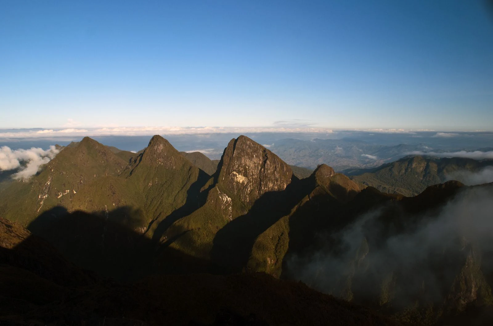 Mountain peaks of Marojejy National Park with clouds in the background and clear blue sky