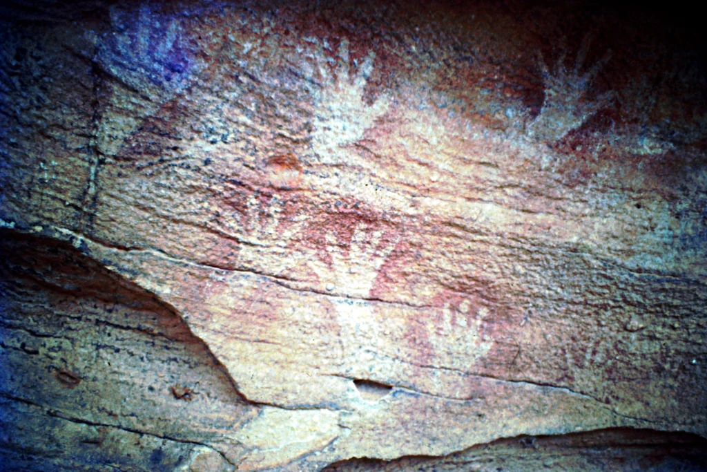 Hand stencils painted on a textured rock surface in Mutawintji National Park