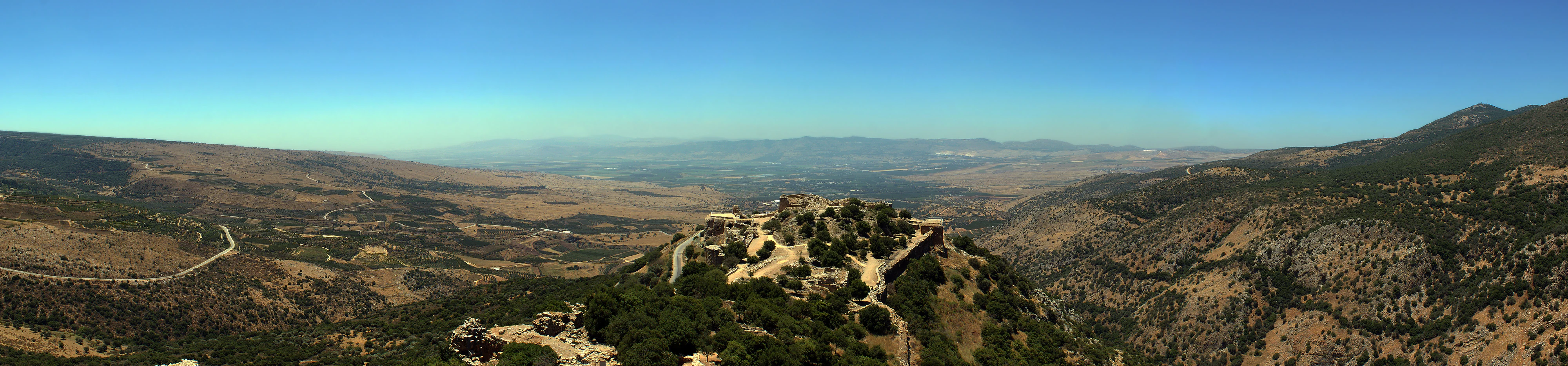 Nimrod Fortress on a hilltop with surrounding mountainous landscape under clear blue sky