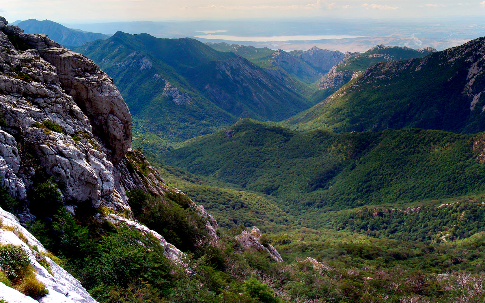 Panoramic view of green mountain valleys and rocky cliffs from Buljma pass