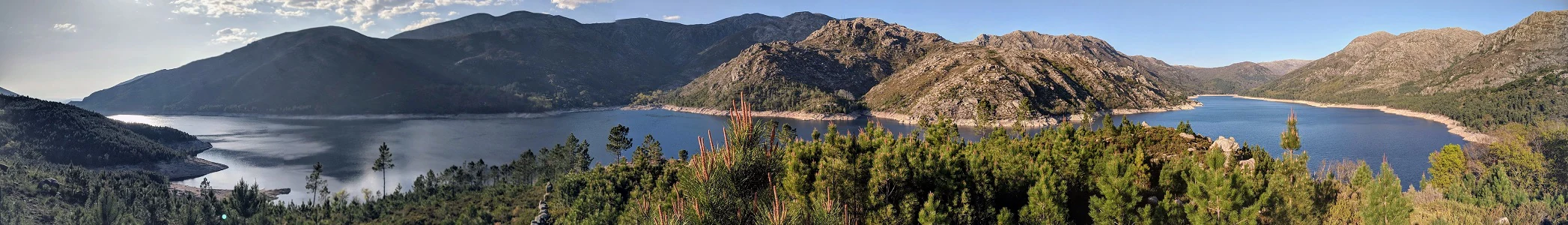 Panoramic landscape of Homem River lake surrounded by mountains and forests, viewed from Campo do Gerês
