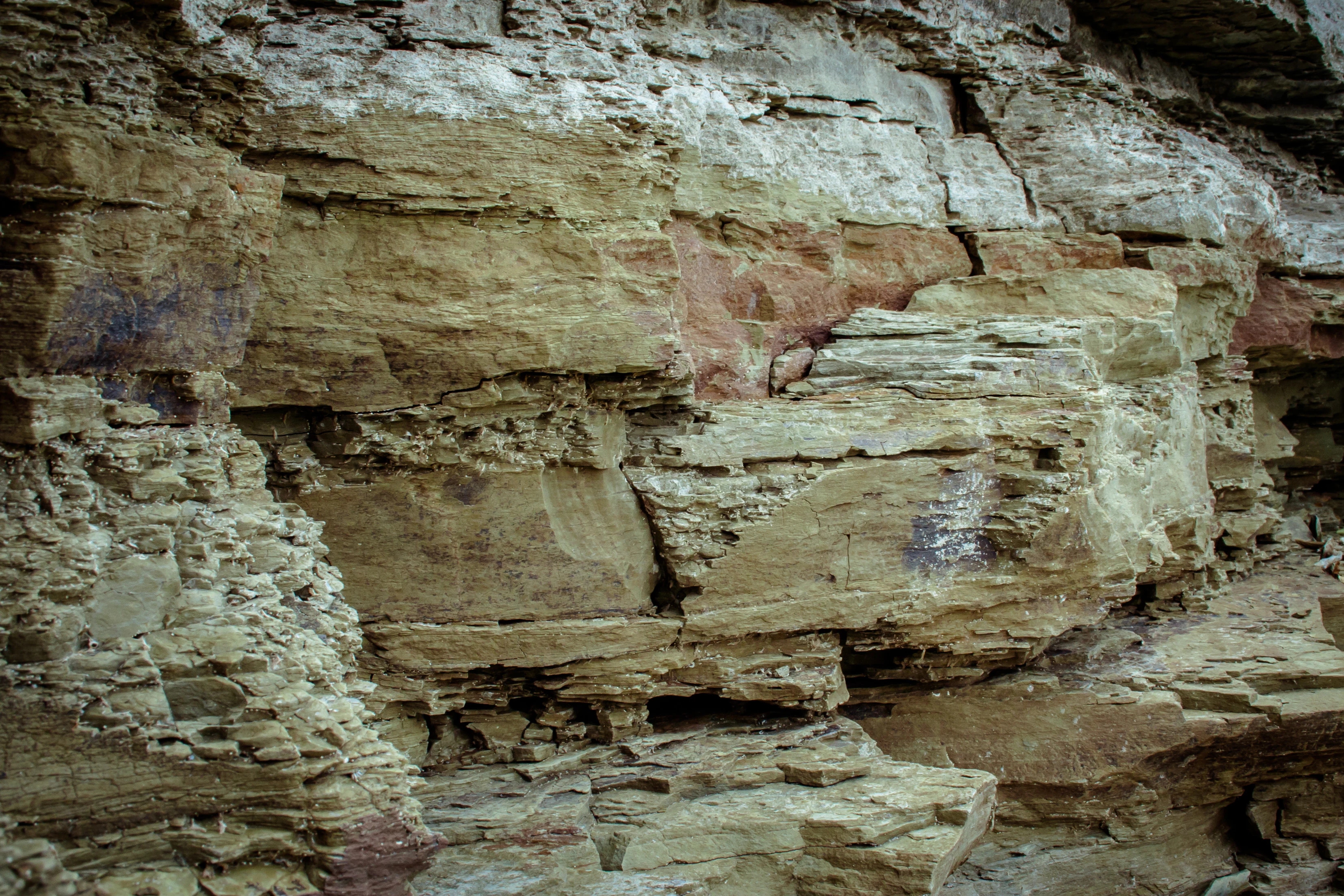 Layered sedimentary rock face with visible strata and weathered surfaces