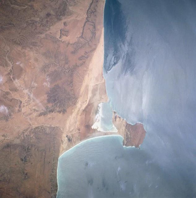 Satellite image of Hafun Peninsula coastline with arid landmass adjacent to the sea