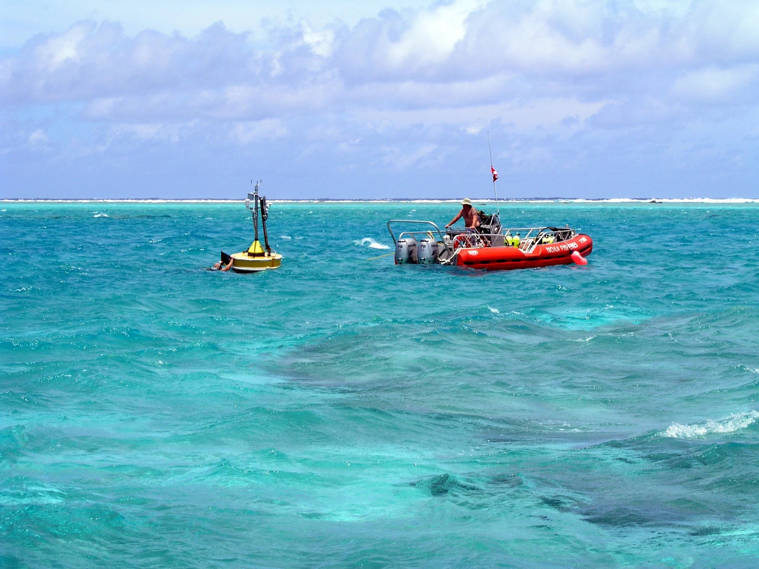 Dos barcos en aguas turquesas del océano con personas realizando actividades de investigación científica