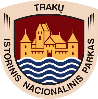 Circular emblem with 'TRAKŲ' text at top, 'ISTORINIS NACIONALINIS PARKAS' text around edges, yellow castle illustration on red background, and blue-white wavy lines representing water