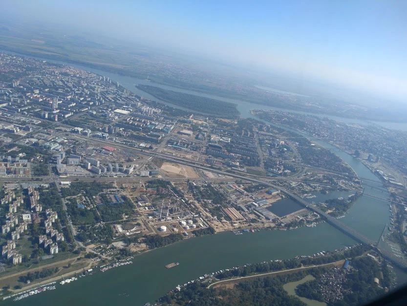Aerial view of two major rivers meeting in an urban area with city development visible along the riverbanks