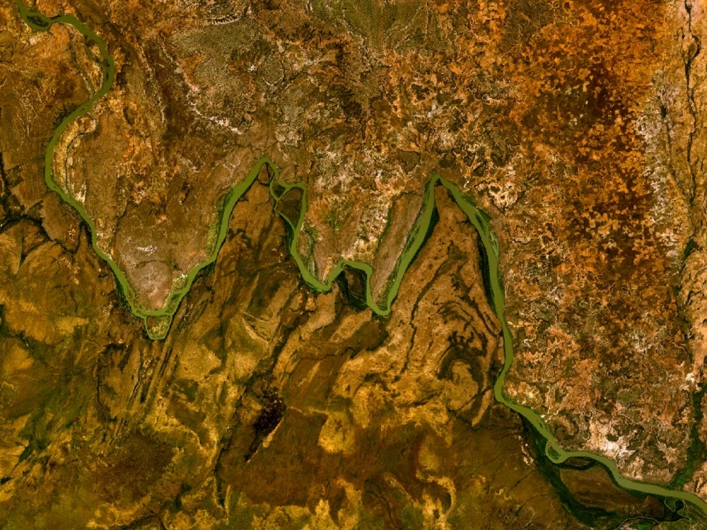 Top-down satellite imagery showing the meandering River Niger winding through arid, textured landscape, forming sharp angular bends.